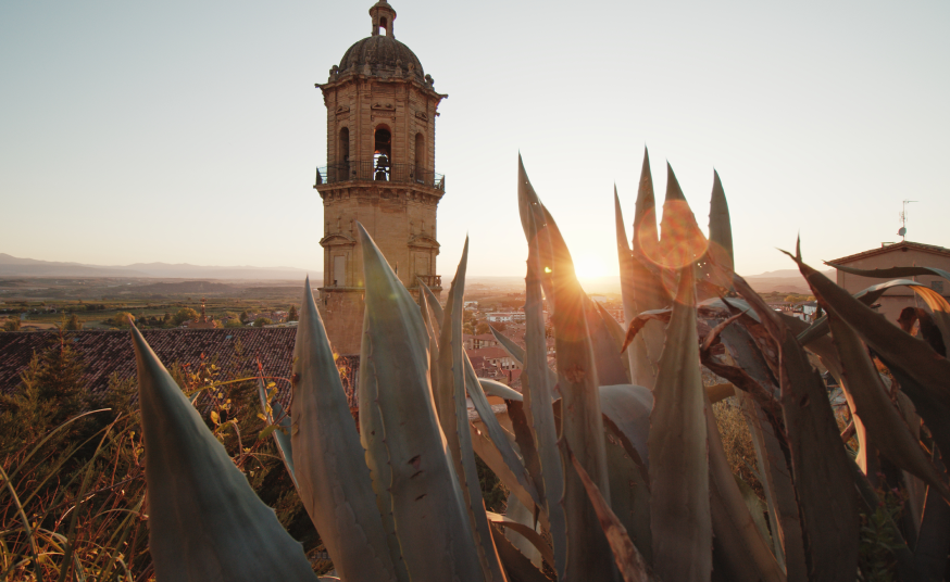 mage of a church steeple at sunset